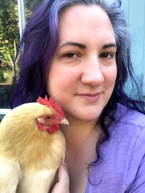 Carissa Burk (formerly known as Carissa Bonham) is the author of the best selling chicken keeping book: Proven Techniques for Keeping Healthy Chickens Carissa Burk - a woman in her late 30's with purple and silver hair holding a buff orpington chicken